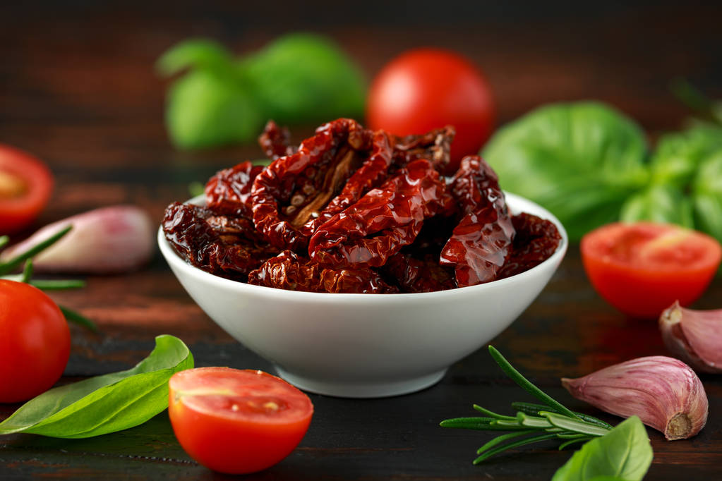 stock-photo-sun-dried-tomatoes-in-white-bowl-with-fresh-herbs-and-spices-on-wooden-table?token=w1725354821lHsL5ZrE4jD7zEh6kCqByqg41kdvV
